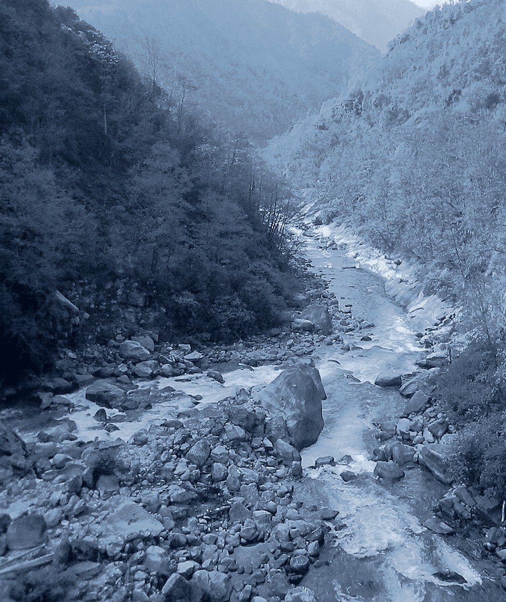 River running through a rocky canyon, in blue-grey